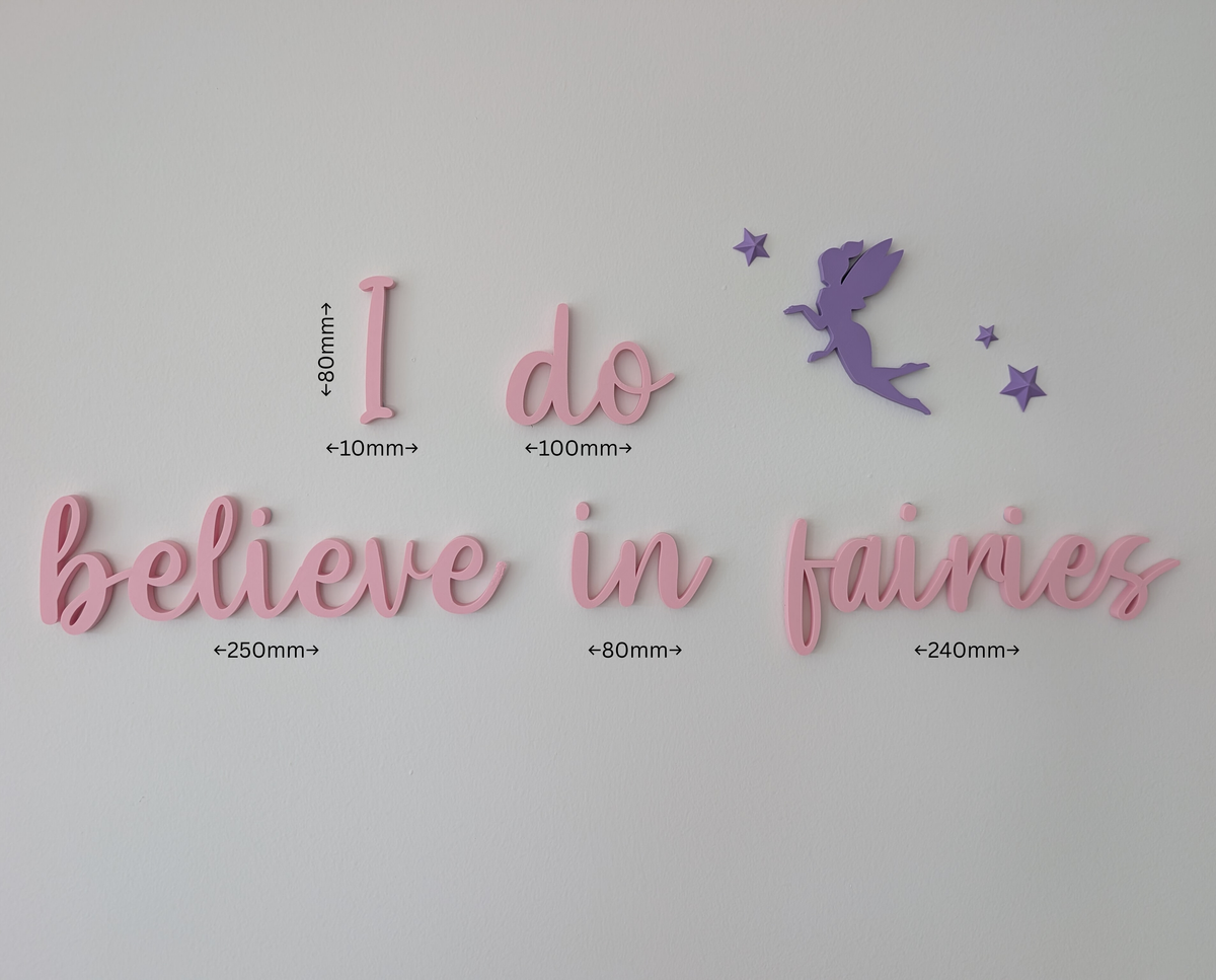 Decorative wall art with 'I do believe in fairies' text and a fairy silhouette on a light gray background.
